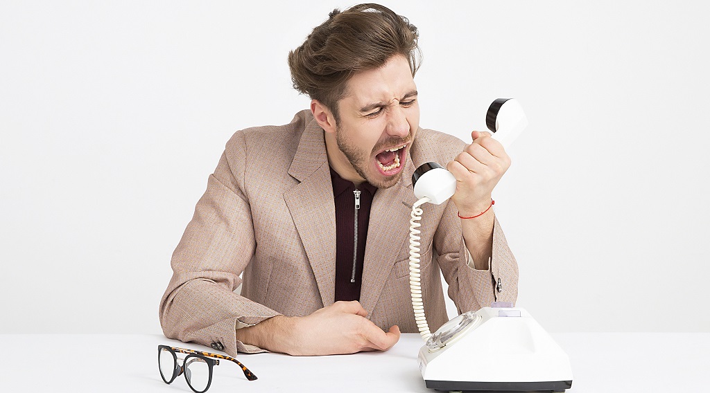 man-wearing-brown-suit-jacket-mocking-on-white-telephone-1587014 (1)